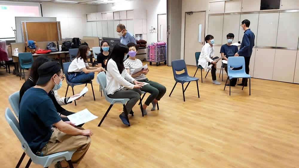 Students taking photos with Caring Leaders and Mindful Self-Compassion tote bags.