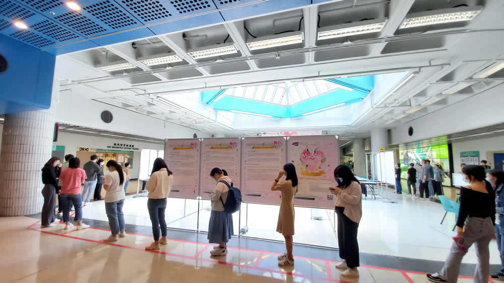 Students taking photos with Caring Leaders and Mindful Self-Compassion tote bags.